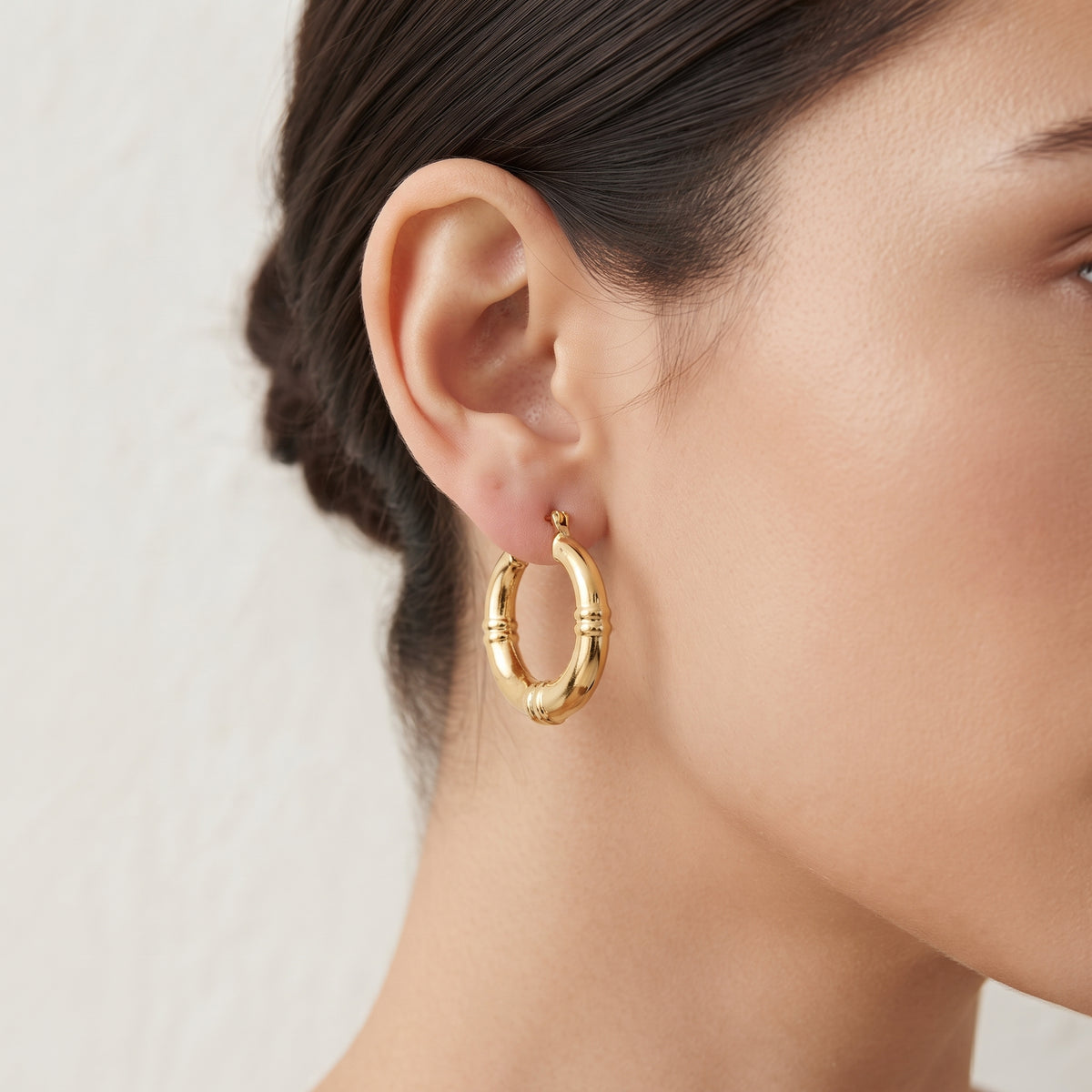BE365 gold-tone hoop earrings worn on model
