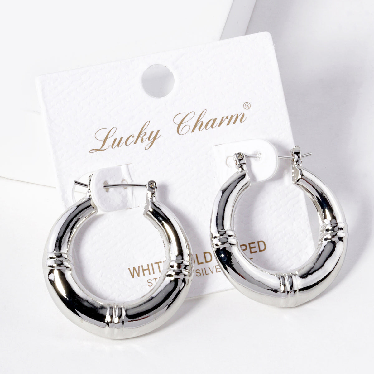 BE365 silver-tone hoop earrings on display card