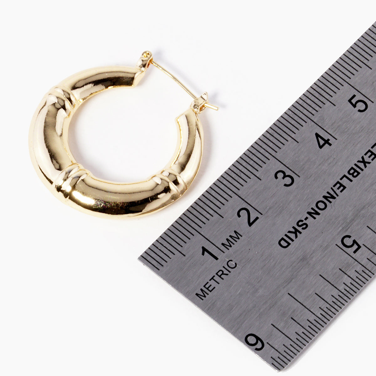 BE365 hoop earring beside metric ruler
