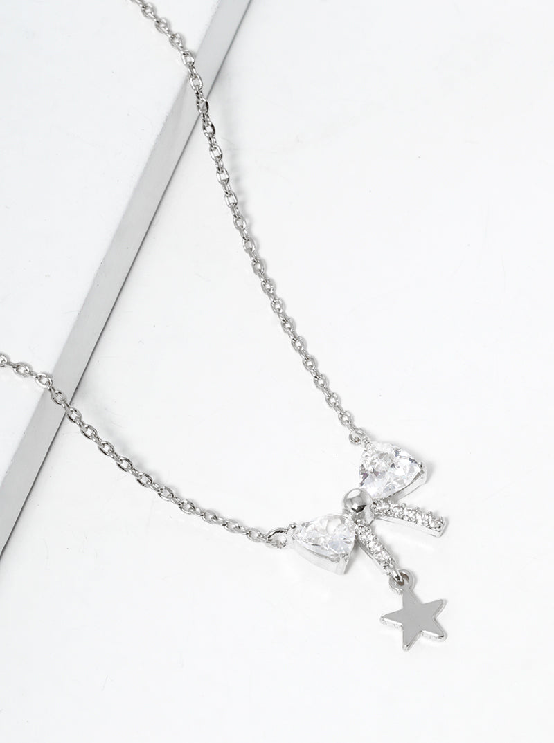 White Gold Dipped CZ Pave Ribbon Bow With Star Drop Pendant Necklace