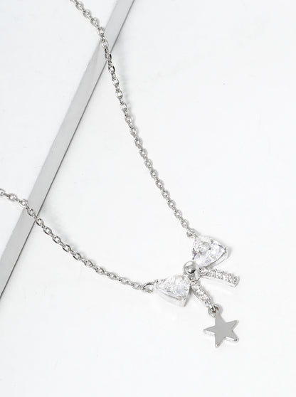 White Gold Dipped CZ Pave Ribbon Bow With Star Drop Pendant Necklace